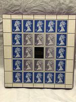 Photo of a full sheet of blue 3p and gray 5p stamps featuring the profile of Queen Elizabeth II with the text 'Britain in Miniature' in the center.