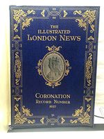 Front cover of the 1937 coronation record book showing blue leather or leatherette cover with gold embossed decorative designs and central portrait of a crowned figure.