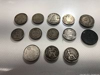 Top view of all 13 coins laid out showing their size and general condition.