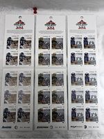 Full view of three Canada Post 2012 Grey Cup 100th football stamp booklets arranged side by side, showing multiple stamps with football player images and Canadian postal logo.