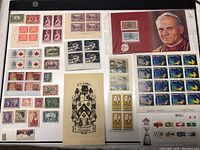 Full view of the lot showing multiple sets of Canadian stamps, including commemorative and definitive issues, mounted on black display cards.