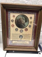 Full view of framed Pre Decimal Coinage of Queen Elizabeth II collection showing the frame, coins arranged around a large central coin image, and descriptive text.