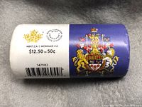 Photo of 2016 Royal Canadian Mint 50-cent coin roll side view showing pricing and barcode with Canadian Mint logos.