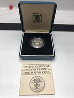 UK Silver Proof One Pound coin displayed in presentation box with information card included.