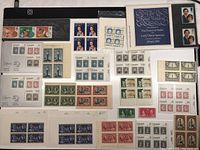 Top view showcasing a variety of vintage Canadian postage stamps in perfect condition including commemorative and definitive issues from different years.