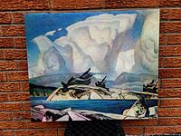 Full view of the stretched and framed canvas against a brick wall