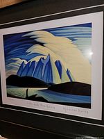 Close-up photo of the framed print showing signature, title, and edition number on the print.