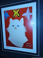 Close-up of the art print showing the white cat with butterflies on a red background, signed by Maud Lewis, numbered 9/50.