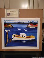 Full view of the unframed fine art print showing the entire harbor scene with boat, seagulls, and buildings. The print measures 20x24 inches and is attached to a backing board with a card about Maud Lewis visible above.
