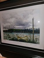 Close-up of the fine art print showing the detailed depiction of a yellow canoe on a lake with trees and clouds in the background.