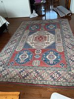 Full view of the rectangular rug laid flat on a hardwood floor
