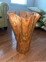 Front perspective view of the wooden driftwood bin, showcasing natural wood texture and irregular top edge with warm golden brown tones.