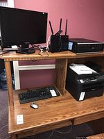 Photo showing the full setup on wooden desk: Samsung monitor, ASUS dual-band router, HP Compaq computer case, Lenovo keyboard and wireless mouse below.