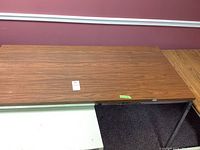 Top view of the wood grain desk surface showing wood pattern and wear.