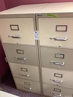 Front view of two matching Bonnex four-drawer filing cabinets side by side showing handles, locks and label holders