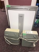 Lot shows two beige Philips heaters and one white Sharp air purifier with model FP-N40CX labeled, cords wrapped around heaters.
