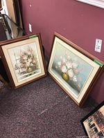 Two original framed floral paintings on floor, showing overall condition and size difference