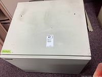 Top view of white metal Sharp cabinet showing worn surface and minor discoloration.