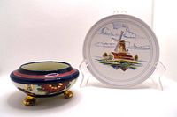 Photo showing the small decorative plate with windmill painting and the Dhalia patterned dish with three legs on a white background.