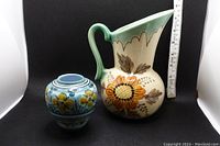 Two Gouda pottery pieces side by side, showing relative size and decorative patterns.