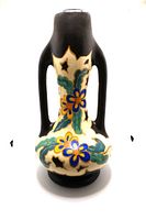 Front view of the large Gouda style pottery vase showing floral designs and black handles.