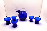 Photo showing the cobalt blue decanter and six matching cordial glasses in a studio white background.