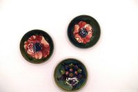 Overhead view of three bowls showing interior floral motifs