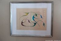 Full view of the framed Native Art print showing the abstract design in green, blue, and brown on beige background with matting and silver frame.