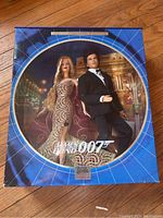 Front view of the boxed set showing both dolls together against a decorative backdrop.