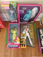 Group shot of four boxed Barbie dolls