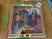 Front view of sealed box showing male and female dolls in Arabian Nights costumes with window frame and background.