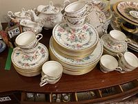 Wide view showing stacks of plates, cups, saucers, sugar bowl, creamer and tureen on display