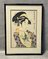Front view of framed Japanese woodblock print showing a woman in traditional attire with floral kimono and hair ornaments.