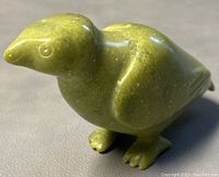 Front angled view showing the carved green soapstone bird with detailed beak, feet, and eyes.