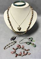 Full lot of vintage Chinese cloisonné enamel costume jewelry displayed including necklaces, bracelets, earrings.
