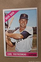 Front side of the 1966 Topps Carl Yastrzemski baseball card showing player in batting stance with Red Sox team banner and name.