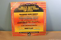 Front cover of Blue Note's Three Decades of Jazz Volume 1 1949-1959 gatefold jacket showing featured artists list with colorful striped tree design.