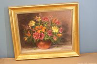 Full view of the framed flower still life painting showing the flowers and frame.