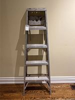 Front view of the 4 ft metal ladder showing all steps and platform