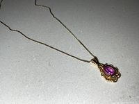 Full view of necklace laid flat showing chain and pendant