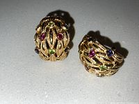 Top view of both earrings showing textured design and gemstone placement