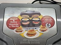 Close-up of the top lid graphic on the Hamilton Beach breakfast sandwich maker showing quick and easy preparation with ready time of 5 minutes