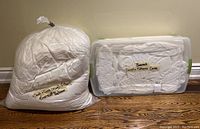 Two plastic bags with king size duvet cover, pillows, and mattress cover, labeled Basement Bedroom