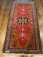 Full view of rug laid flat on wooden floor