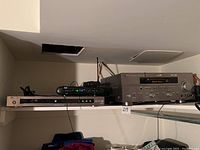 Shelf setup showing Yamaha AV receiver, Yamaha CD player, and a black electronic device