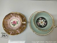 Overhead view of two cup and saucer sets side by side showing pink and mint green interiors