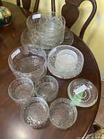 Overview of all ten glass pieces arranged on dining table