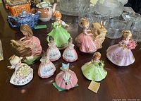 Overview of ten Josef Originals figurines and music boxes arranged on table