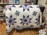 Full view of quilt draped showing star blocks and border