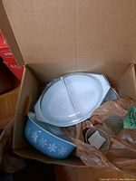 Box containing divided dish, mixing bowl and lid